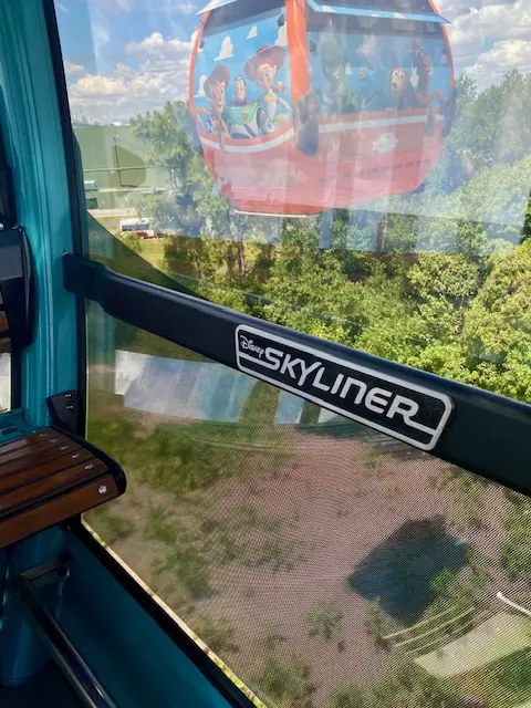 Disney Skyliner gondola passing outside a guest cabin