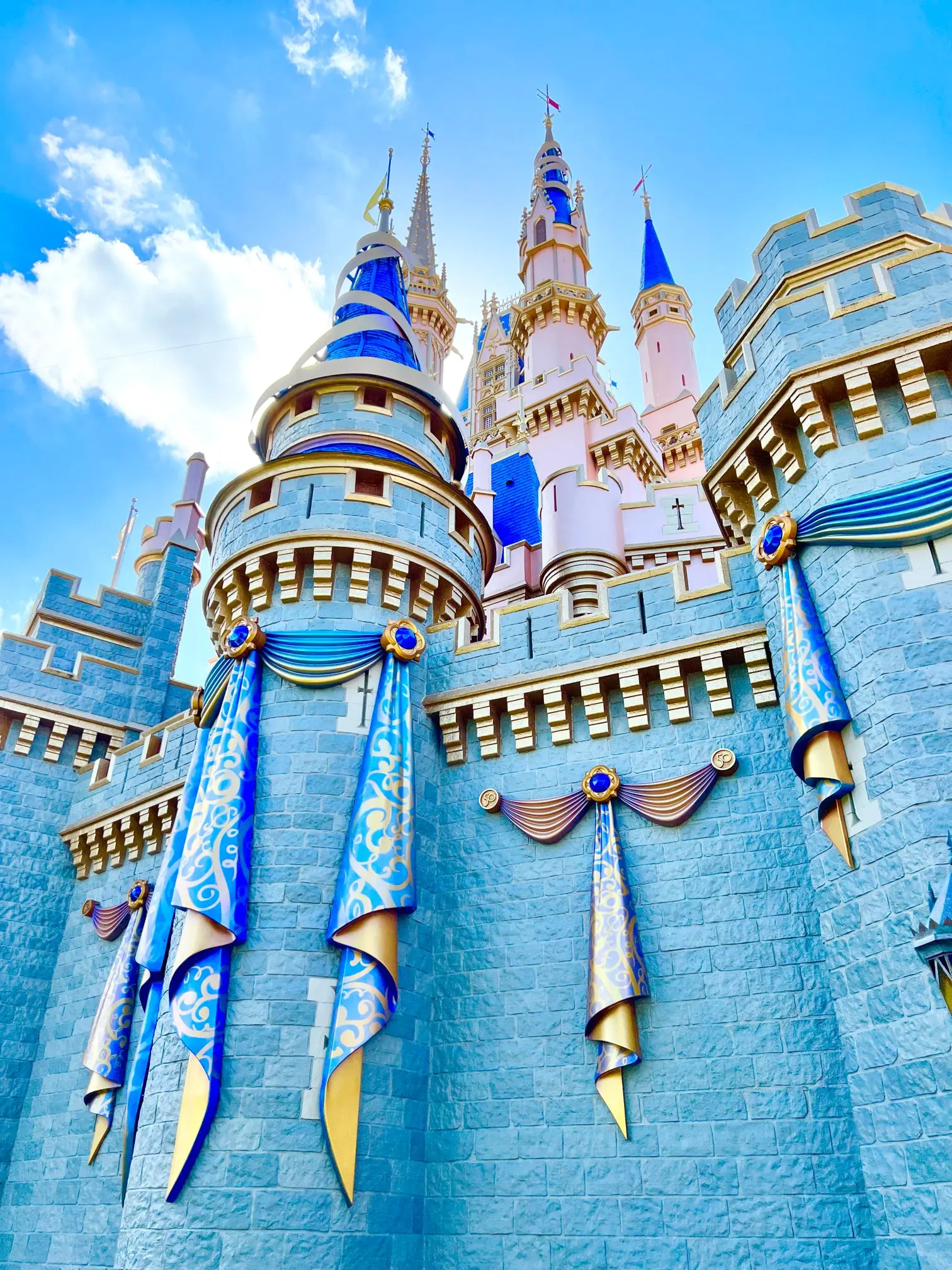 A close-up angle of Cinderella Castle with bright blue and gold details