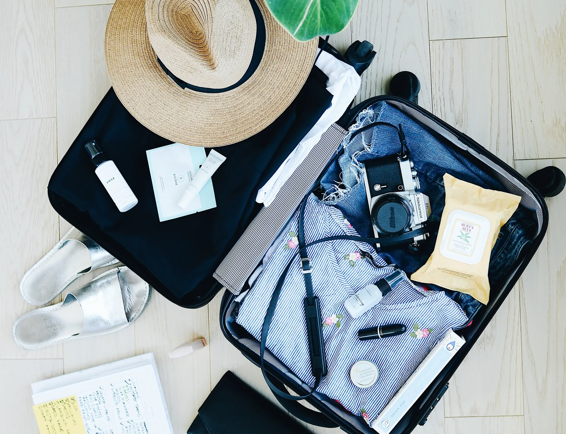 Open suitcase thoughtfully packed with vacation essentials