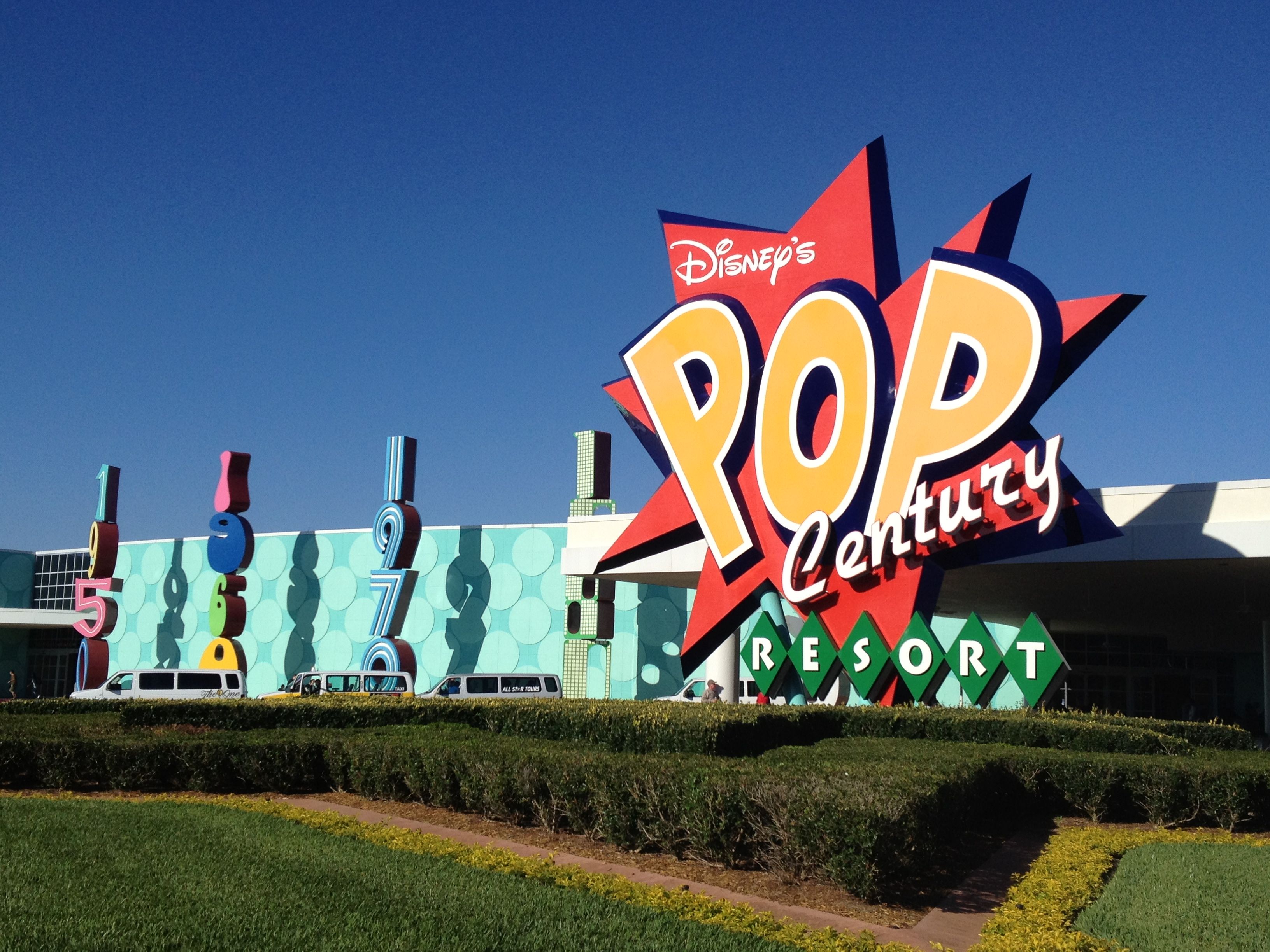 The giant colorful Disney's Pop Century Resort entrance sign and decade-themed building