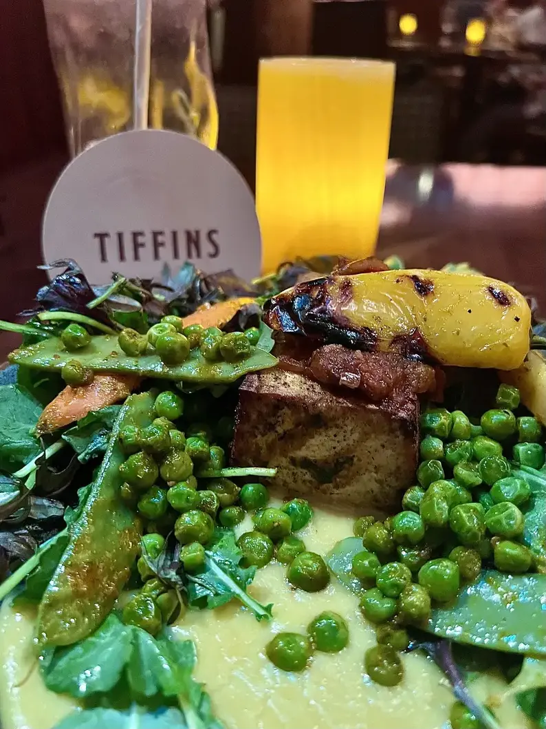 A complete colorful entrée with Tiffins branding