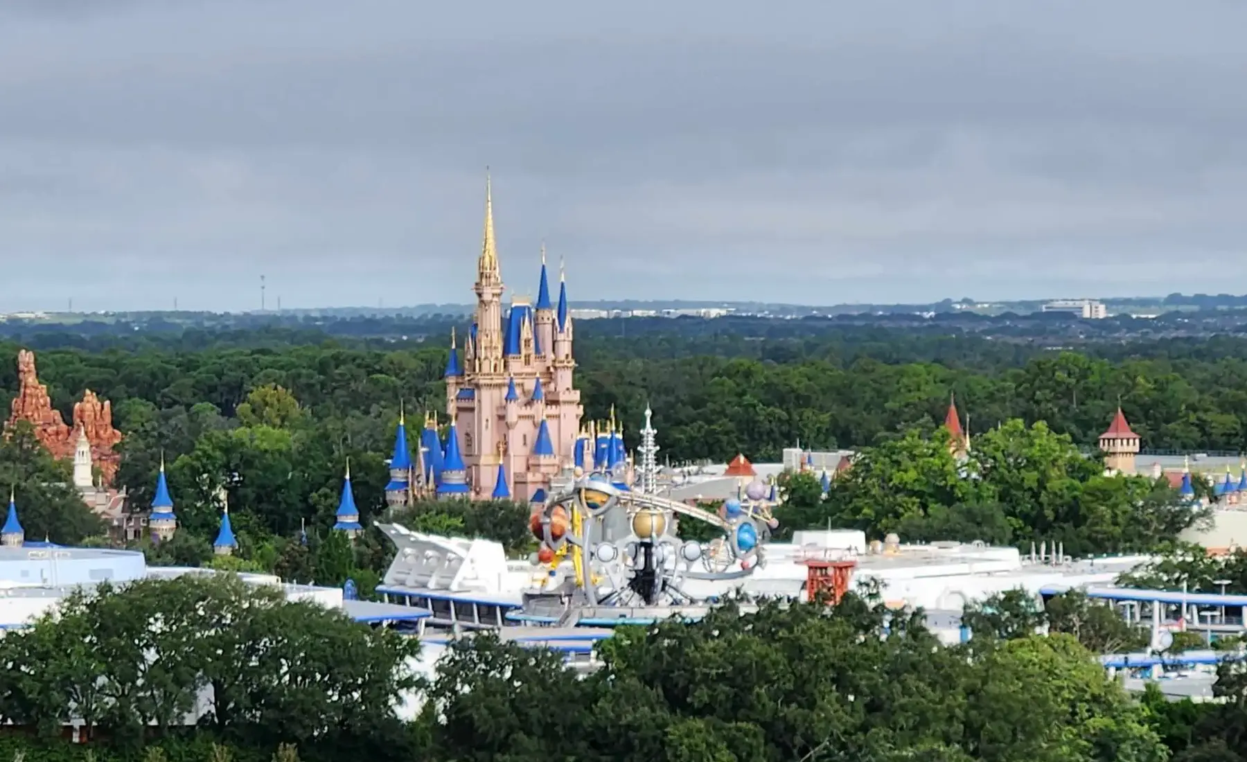 A wide aerial view of Cinderella Castle and Magic Kingdom