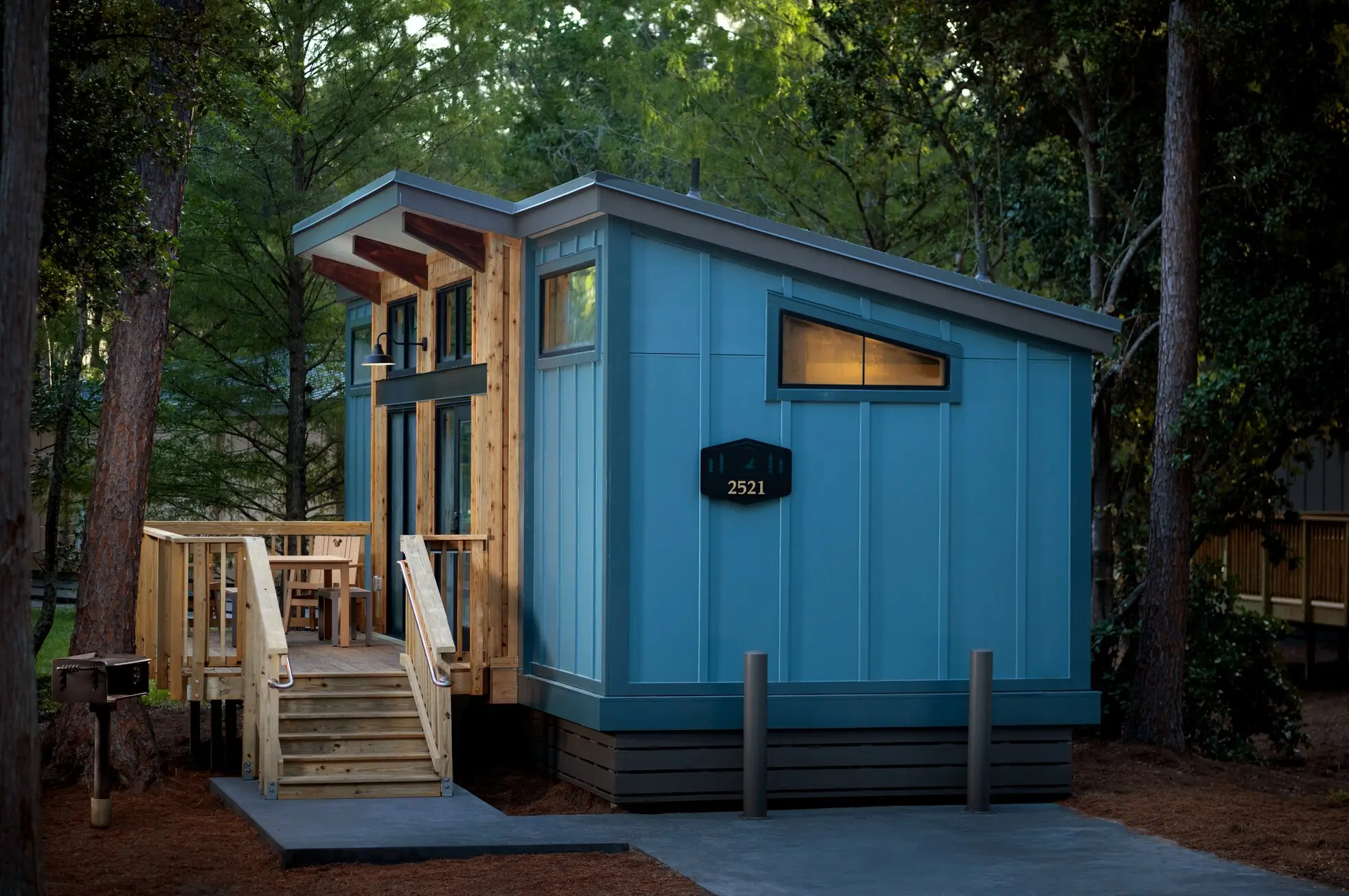 A new blue Disney Vacation Club cabin with a private deck at Fort Wilderness