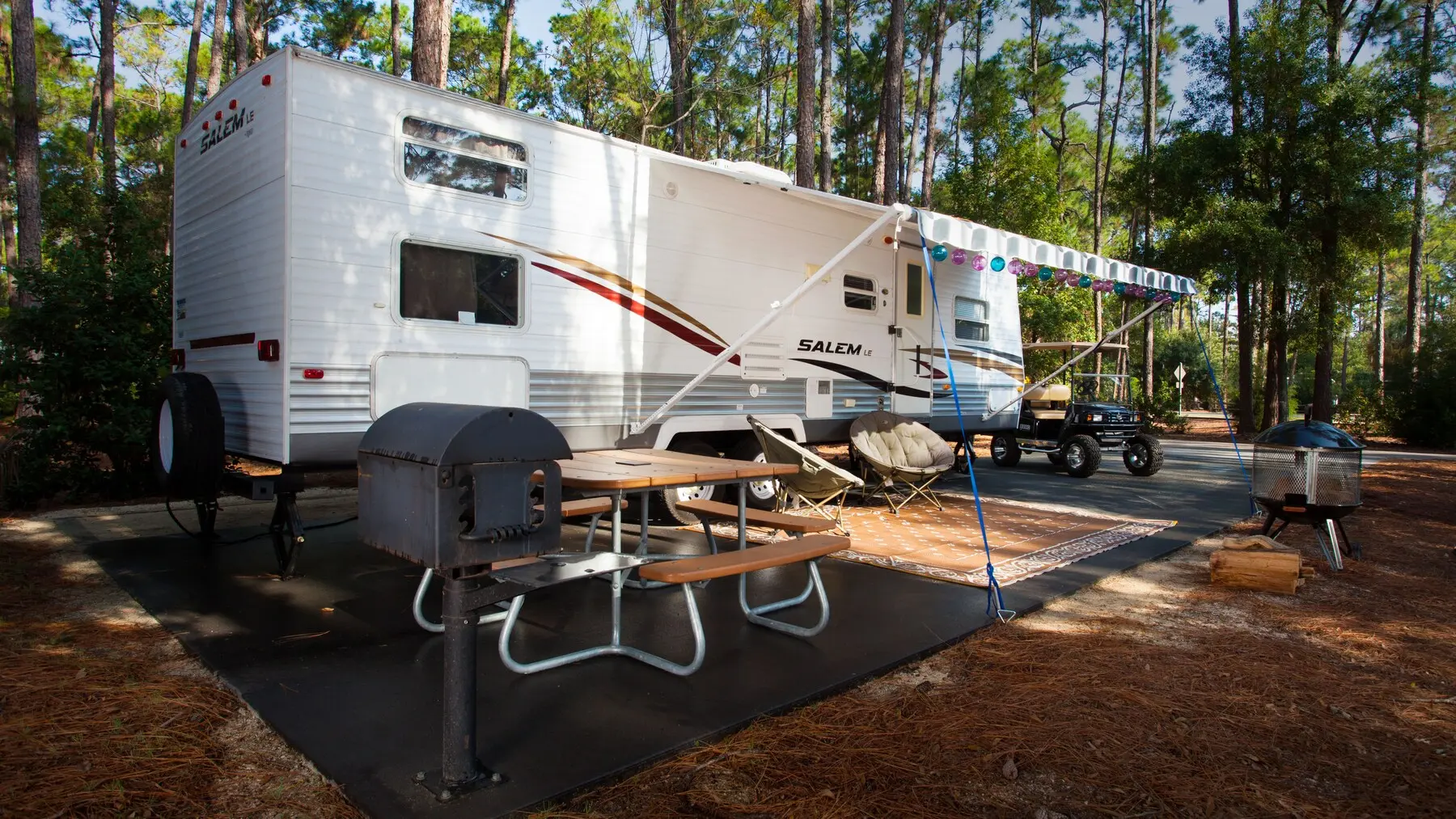 An RV on a fully equipped campsite pad at Disney's Fort Wilderness Resort & Campground