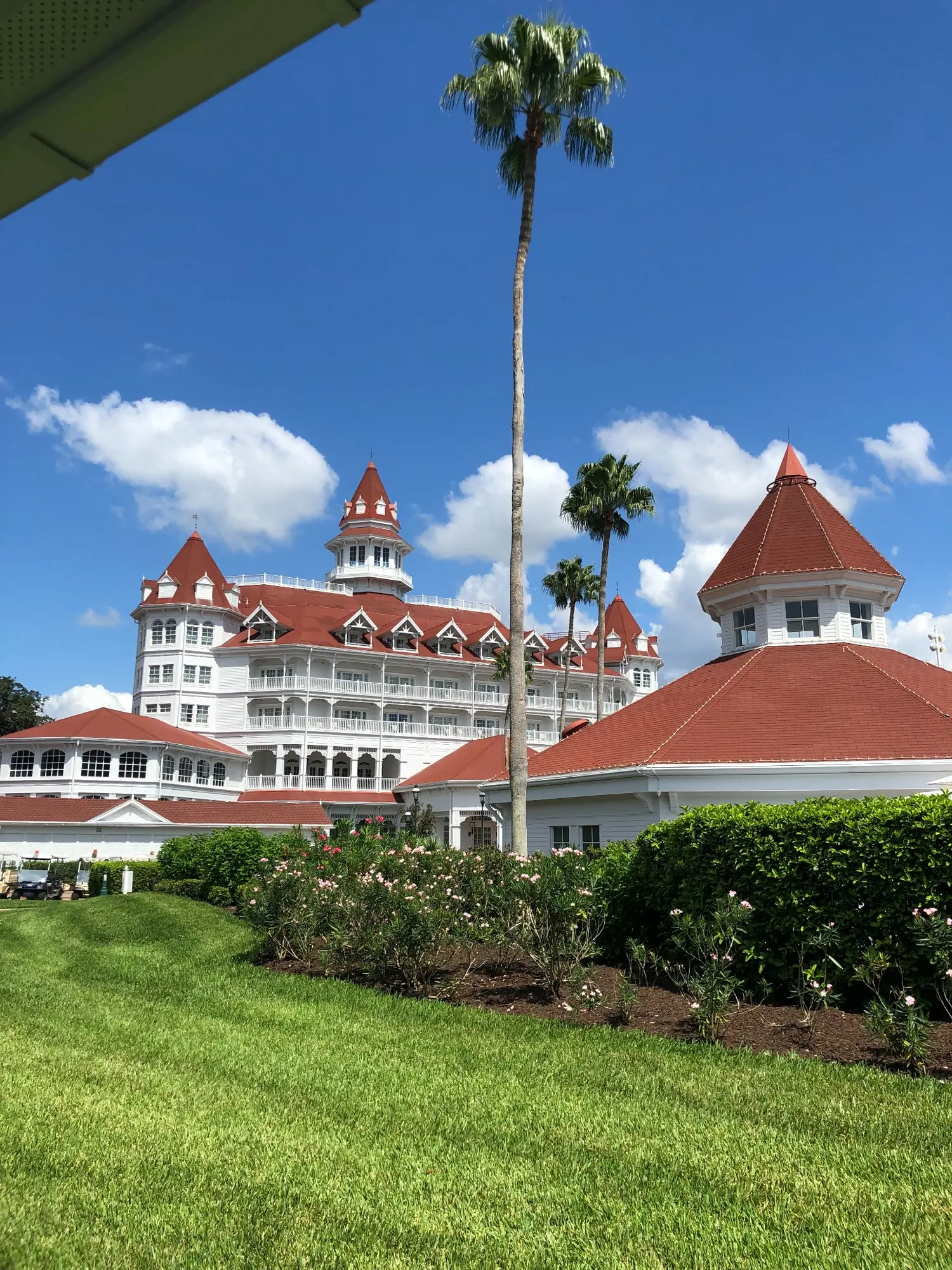 Disney’s Grand Floridian Resort and Spa rising above its gardens and red roofs