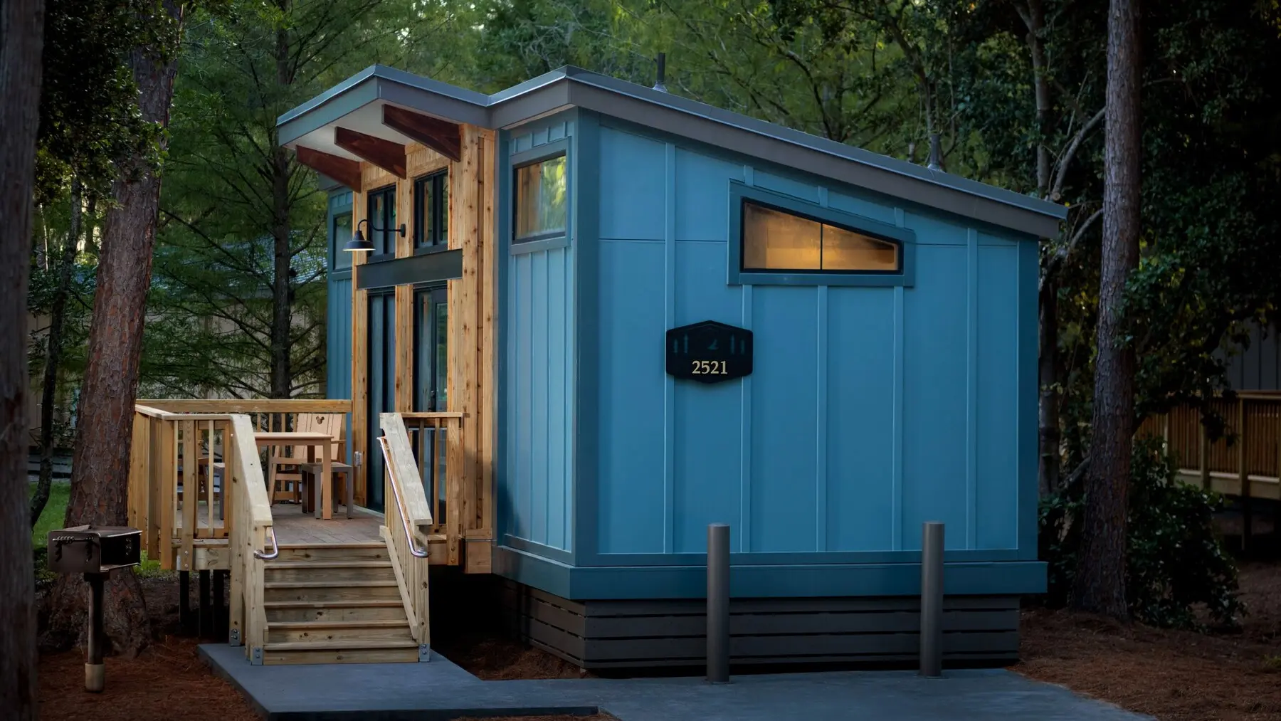 A crisp exterior view of a new blue cabin at Disney’s Fort Wilderness Resort