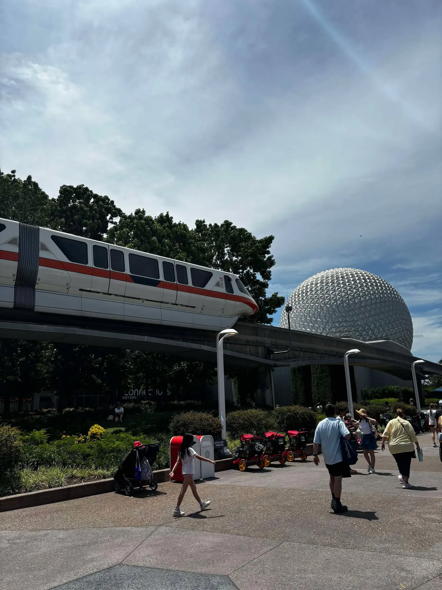 The Disney Monorail gliding beside Spaceship Earth