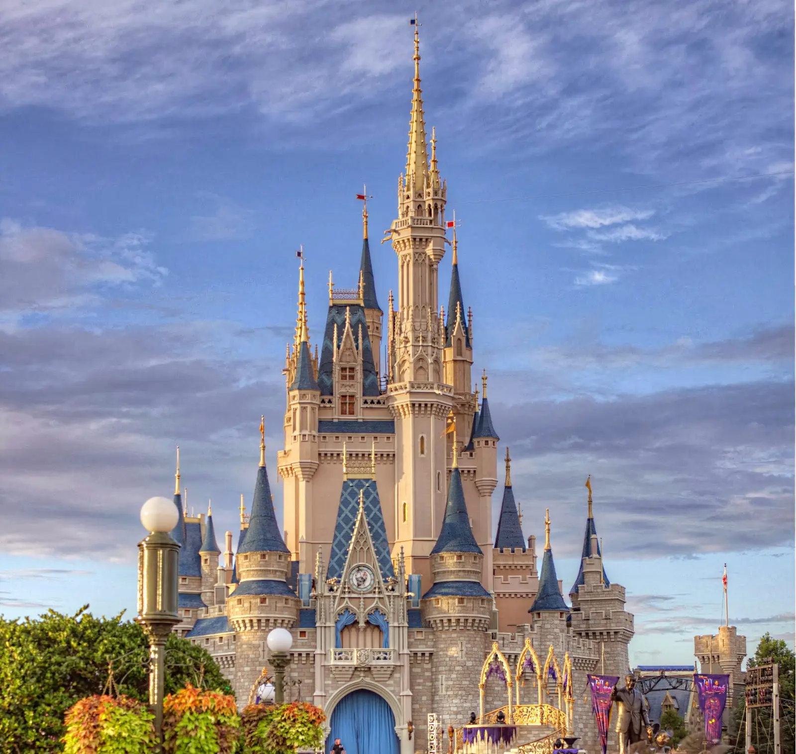 Cinderella Castle glowing against a blue and lavender evening sky