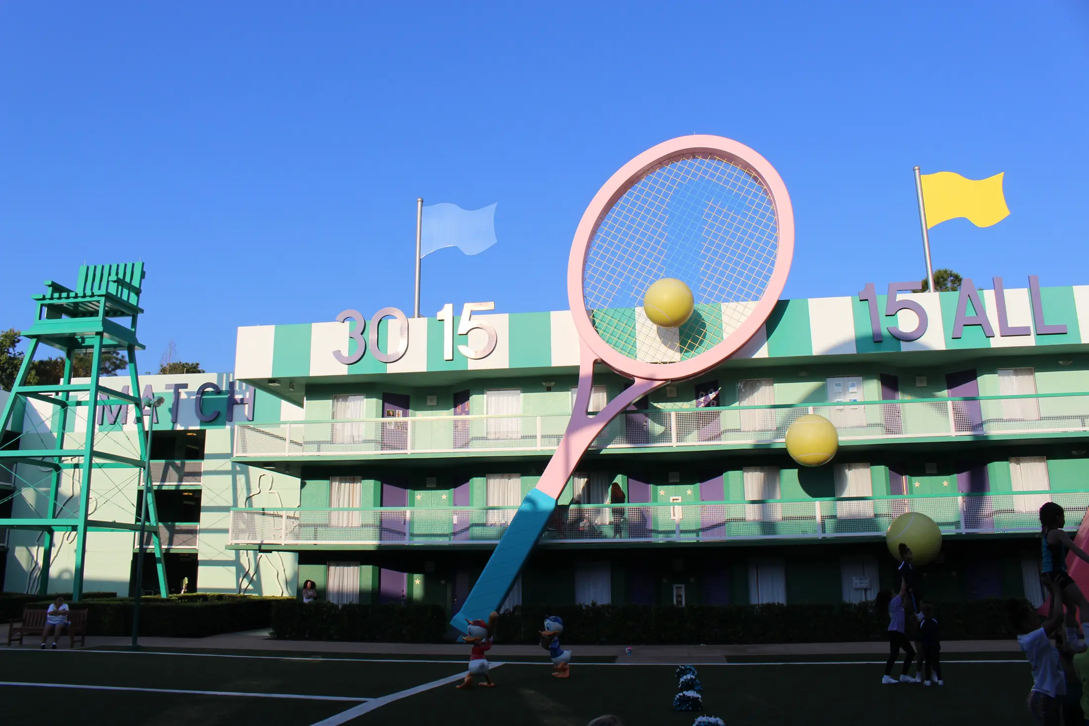 A giant tennis racket and tennis ball outside the Center Court buildings at Disney's All-Star Sports Resort